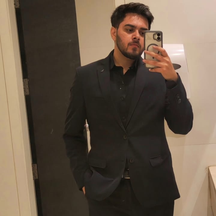 Mirror selfie in a charcoal suit