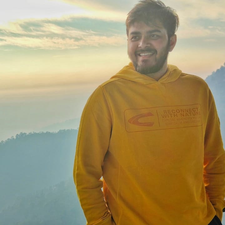 In a yellow hoodie above the clouds in the hills